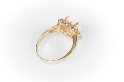 Yellow gold daisy ring set with an oval cabochon...