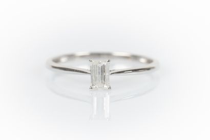 White gold solitaire set with a baguette...