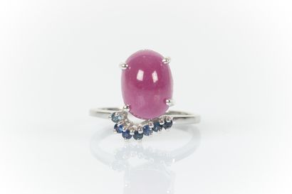 White gold ring centered with an oval cabochon...