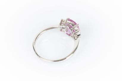 White gold ring set with an oval pink sapphire...