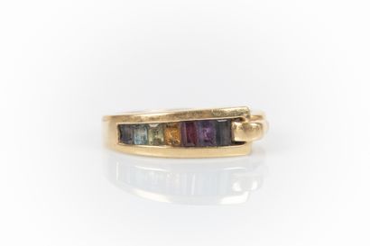 Gold ring set with calibrated gemstones in...