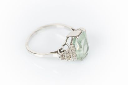 Gold and platinum ring set with an emerald-cut...