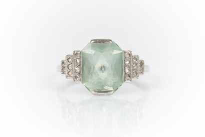 Gold and platinum ring set with an emerald-cut...