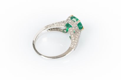 Two-tone gold ring set with an oval emerald...