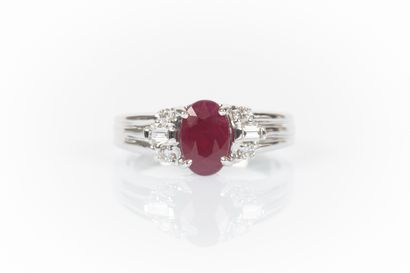 Ring in white set with an oval-cut Burmese...