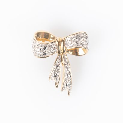Two-tone gold bow pendant set with two round...