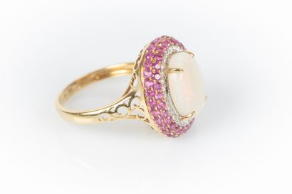 Two-tone gold ring set with an oval cabochon...