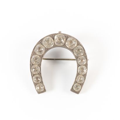 Silver horseshoe brooch set with rhinestones....