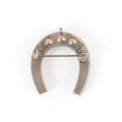 Silver horseshoe brooch set with rhinestones....
