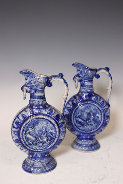 Pair of white and blue earthenware pourers,...