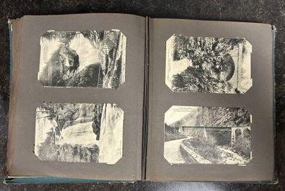 An album containing 208 old postcards of...
