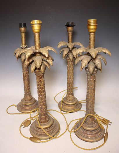 Set comprising four gilded composition palm...