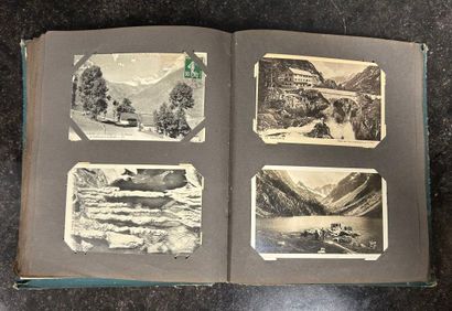 An album containing 208 old postcards of...