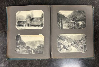 An album containing 208 old postcards of...