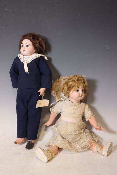 Set of two wooden dolls with porcelain heads...