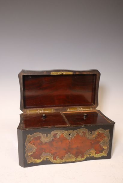 Blackened wood and tortoiseshell marquetry...