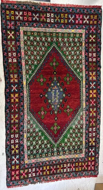 Caucasus rug with geometric design on a red...