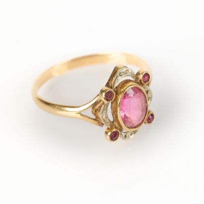 Gold ring set with a garnet in an openwork...