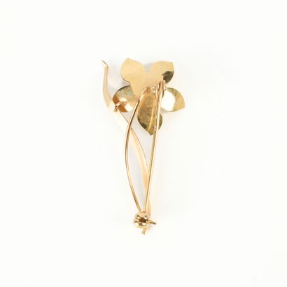 Gold flower brooch set with a cultured pearl....