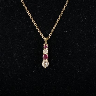 Silver chain holding a gilded metal pendant...