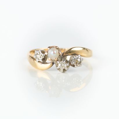 Two-tone gold ring set with three small diamonds...