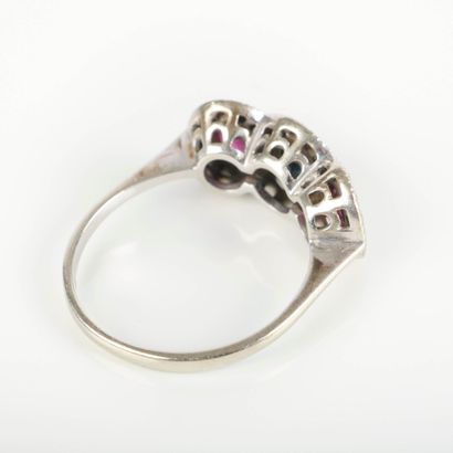 White gold ring set with a sapphire surrounded...