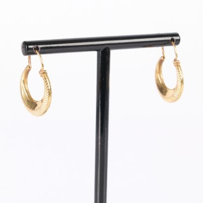 Pair of engraved gold hoop earrings. Diam....