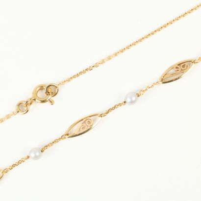 Gold necklace with filigree links alternating...