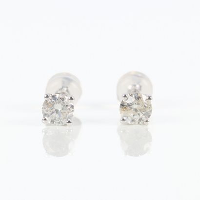 Pair of gold ear studs, each set with a round...
