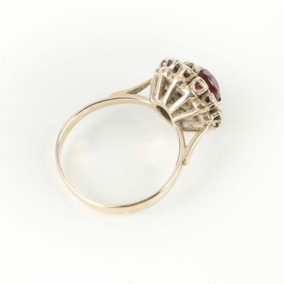 White gold ring set with a red stone in a...