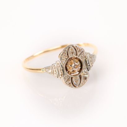 . Two-tone gold ring set with a round diamond,...