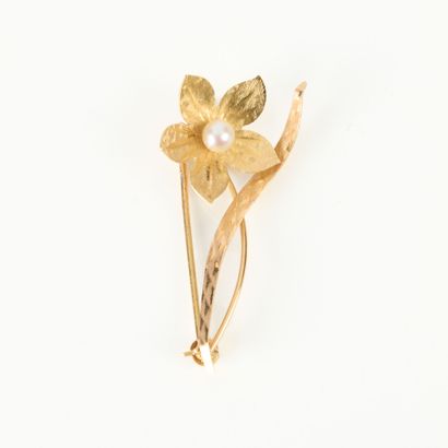 Gold flower brooch set with a cultured pearl....