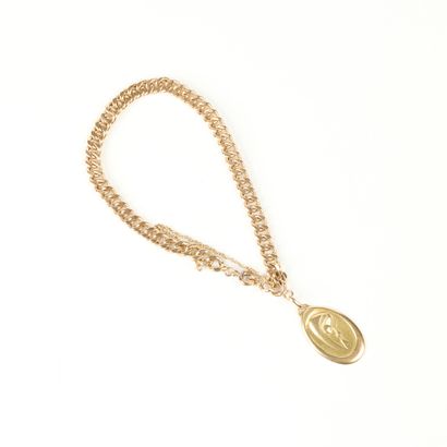 Gold curb chain, safety chain, holding an...