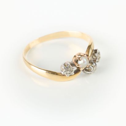 Two-tone gold ring set with three small diamonds...