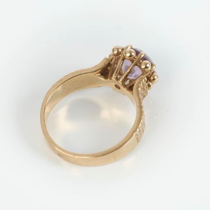 Small gold ring set with a round amethyst,...