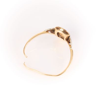 . Two-tone gold ring set with a round diamond,...