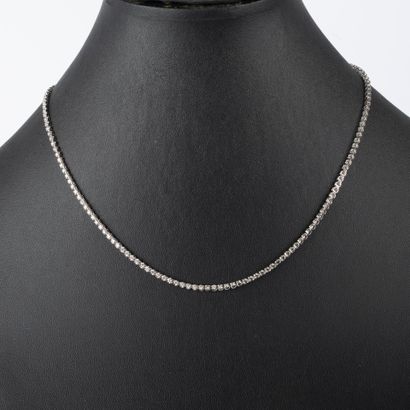 Platinum necklace set with round diamonds...