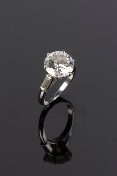 . Gold and platinum solitaire set with a...