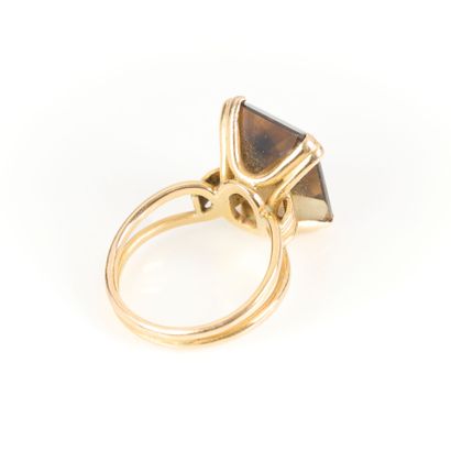 Gold ring set with an emerald-cut smoky quartz....
