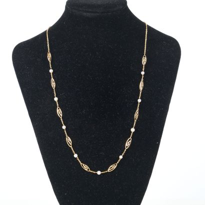 Gold necklace with filigree links alternating...