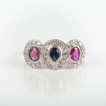 White gold ring set with a sapphire surrounded...