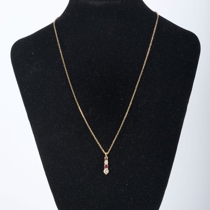 Silver chain holding a gilded metal pendant...