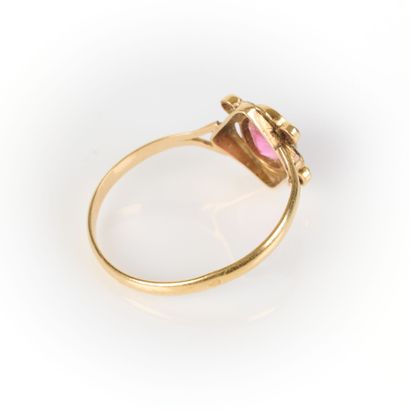 Gold ring set with a garnet in an openwork...