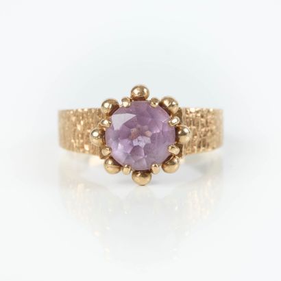 Small gold ring set with a round amethyst,...