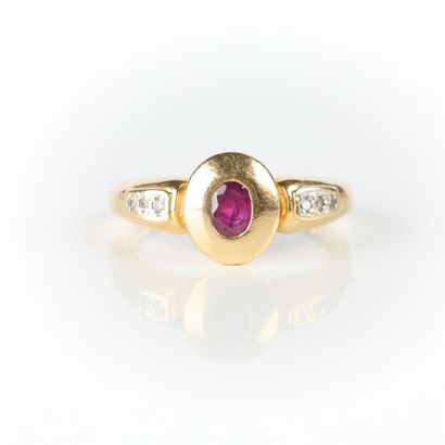 Gold ring set with an oval ruby (worn) with...