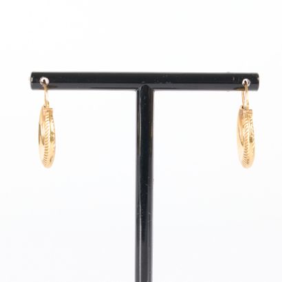 Pair of engraved gold hoop earrings. Diam....