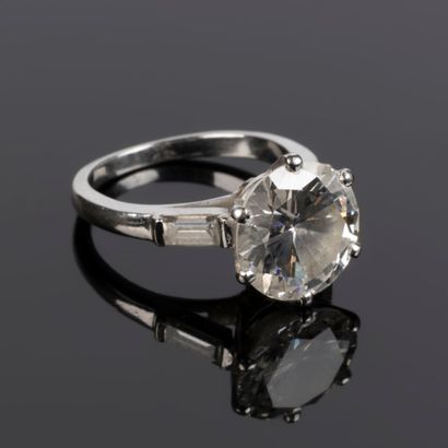. Gold and platinum solitaire set with a...