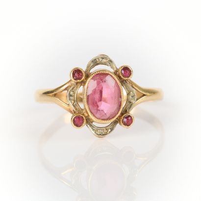 Gold ring set with a garnet in an openwork...