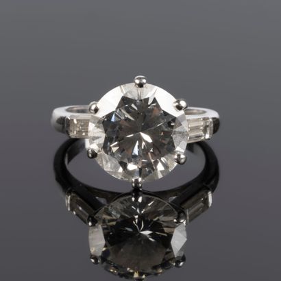 . Gold and platinum solitaire set with a...
