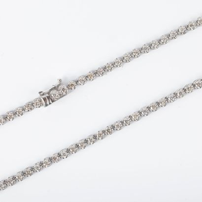 Platinum necklace set with round diamonds...